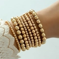 Macro-opname van gelaagde gouden kralenarmbanden met diverse kraalgroottes - Lichtgoud (25639-G)