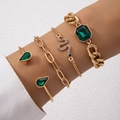 Detail of four-piece gold bracelet set featuring emerald green gems and snake charms - Snake And Emerald Gemstone Four Piece Gold Bracelet Set (24614-gold)