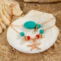 Bohemian gold layered anklet set with turquoise stone and starfish charm on beach sand - Starfish Small Fish Ocean Pendant Style (26767-colour)
