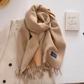 Classic beige and brown houndstooth tassel scarf styled on a soft winter coat - Yellow Blue