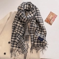 Close-up of black and white plaid scarf with fringe on a beige wool coat - Black (FYR-292-Black)