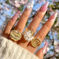 Gold-plated ring set with unique lip design and pearl details on a model hand - Lip Shape Pearl Gold Style (26614-gold)