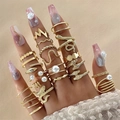 Detail shot of vintage gold rings set featuring snake, pearl, and butterfly designs - 21-Piece Golden Snake & Pearl Ring Set (26485-gold)