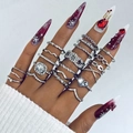 Macro shot of silver ring set with butterfly, moon and heart motifs on a model's hand - Silver Style (26518-silver)