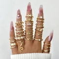 Close-up of bohemian gold ring set featuring butterfly, snake, and pearl motifs - Gold Style (26502-gold)