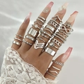 Macro detail of bohemian silver alloy rings set featuring infinity and sunburst motifs - Silver Style 26603