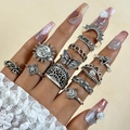 Detailed view of vintage silver rings with sun, moon, and butterfly designs on hands - Silver Style (26658-silver)