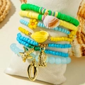 Detail shot of ocean-themed layered bracelets with sea shells, starfish, and colorful beads - Colorful Polymer Clay Ocean Set (31492-bra-ygb-G)