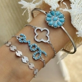Close-up of Bohemian silver bracelets featuring turquoise floral and leaf details on wrist - Love Letter Blue