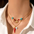 Hawaiian beach layered necklace with chili, evil eye, and golden elephant pendants - Elephant & Red Chili Style (26349-gold)