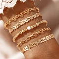 Five-piece gold chain bracelet set with white bead detail on a model wrist - Golden Beaded 5-Piece Bracelet Set (3005) / Gold