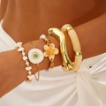 Detail shot of five bohemian bracelets featuring Evil Eye charm and golden textures - Bohemian Vacation Style 5-Piece Set (30327-bra-G)