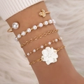 Elegant 5-piece gold bracelet set featuring large pearls, leaves, and a white flower charm - Gold Pearl Flower 5-Piece Set (23465-G)