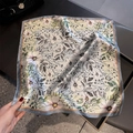 Detail of silk square scarf showing floral print texture and lightweight fabric - Grey Edge