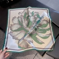 Detail of silk square scarf featuring large green floral peony pattern and hand-rolled edge - Green Trim