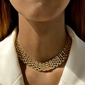 Close-up of golden multi-row woven metal choker necklace on a model's neck - Wide Multilayer Woven Style (25648) / Gold