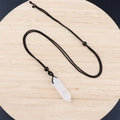Adjustable black cord necklace featuring a polished white crystal hexagonal pendant - Clear Quartz With Cord