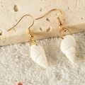Bohemian seashell and starfish drop earrings on beach sand and rock surface - Spiral Conch Style (26904-2-white)