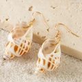 Detail of natural seashell earrings with golden hooks on beach sand display - Spotted Snail Style (26904-5-white)
