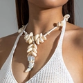Detail view of shell necklace with starfish accents and unique layered horn pendant - White Small Round Beads Layered Shell Tiger Tooth Pendant (29403-white)