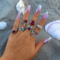 Gothic punk ring set featuring skull hand heart and red rose motifs on a beach - Red Rose Heart Style (27171-silver)