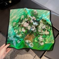 Close-up of silk scarf with green impressionist floral print and light-reflecting texture - Green