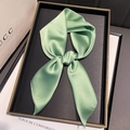 Detail of light green silk scarf tied in elegant bow on decorative luxury tray - Pale Green