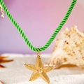 Bohemian gold starfish pendant on green twisted cord necklace set in white beach sand - Green Starfish Pendant Braided Cord Style (27255-2-green)