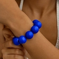 Detail of ethnic style bracelet with large polished royal blue beads on wrist - Blue
