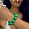 Close-up of ethnic style emerald green beaded bracelet worn on a female wrist - Emerald Green