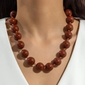 Close-up of bohemian chunky brown resin beads necklace with a high-gloss polished finish - Ethnic Beaded Style (31711) / 18mm Bead Diameter / Brown