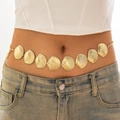 Detail of a golden seashell waist chain accessory worn on denim for beach styling - Fan Shell Style / Gold