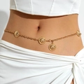 Detail of gold chain belt with diamond-quilted round pendants on a white beach outfit - Round Quilted Pattern Design / Gold