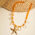 Detail of beach necklace with orange beads, starfish pendant and shell charms - Orange Faceted Bead Imitation Pearl Style (29409-1-orange)