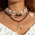 Detail of layered bohemian shell necklace featuring starfish pendant and seed beads - Coffee Multicolor
