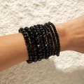 Close-up of bohemian black multi-layer beaded bracelets with faceted beads on wrist - Pure Black Faceted/Smooth Beads Stackable (28437-black)