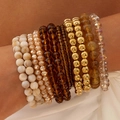 Close-up of bohemian layered bracelets set with marble resin and golden beads - Earth Tone/Amber/Gold Bohemian (30322-bra-brown)