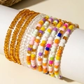 Close-up of bohemian colorful seed bead bracelet set on a white cylinder stand - Multicolor/Amber/Pure White Mix Set (29708-colour)