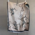 Detail of sika deer jacquard scarf with elegant grey fringes on a textured backdrop - 185x70 / Natural With Black Edge