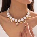 Close-up of bohemian shell and starfish charms on a pearl-like beaded summer necklace - White Ocean Style Multi-pendant Beaded Necklace (29109-white)