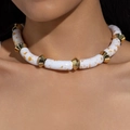 Bohemian acrylic tube necklace with gold splatter and faceted metal beads on model neck - Pop Art Splash Pattern White Curved Tube Necklace (31353)