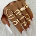 Detail of stacked irregular gold hollow rings on hand with minimalist white background - Gold Hollow Layering Set (30775-ring-G)
