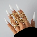 Set of 6 gold rings with butterfly and hollow wave designs on hand with long white nails - Gold Bowknot Geometric Set (28251-G)