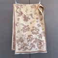 Detail of floral jacquard winter scarf with elegant tassels on a textured backdrop - 185*65cm / Khaki