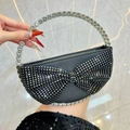 Elegant black evening clutch with rhinestone bow and sparkling circular metal handle - Black