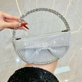 Silver evening clutch bag with sparkling rhinestone bow and ornate crystal handle - Silver