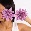 Detailed view of handmade purple fabric sunflower earrings worn by a model - Violet