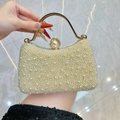 Elegant pearl evening handbag with cream faux pearls and a circular gold metal handle - Off White