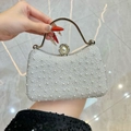 Elegant pearl evening handbag in silver white with metallic handle and clasp detail - White