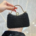 Elegant black beaded evening clutch featuring a large pearl clasp and silver metal handle - Black